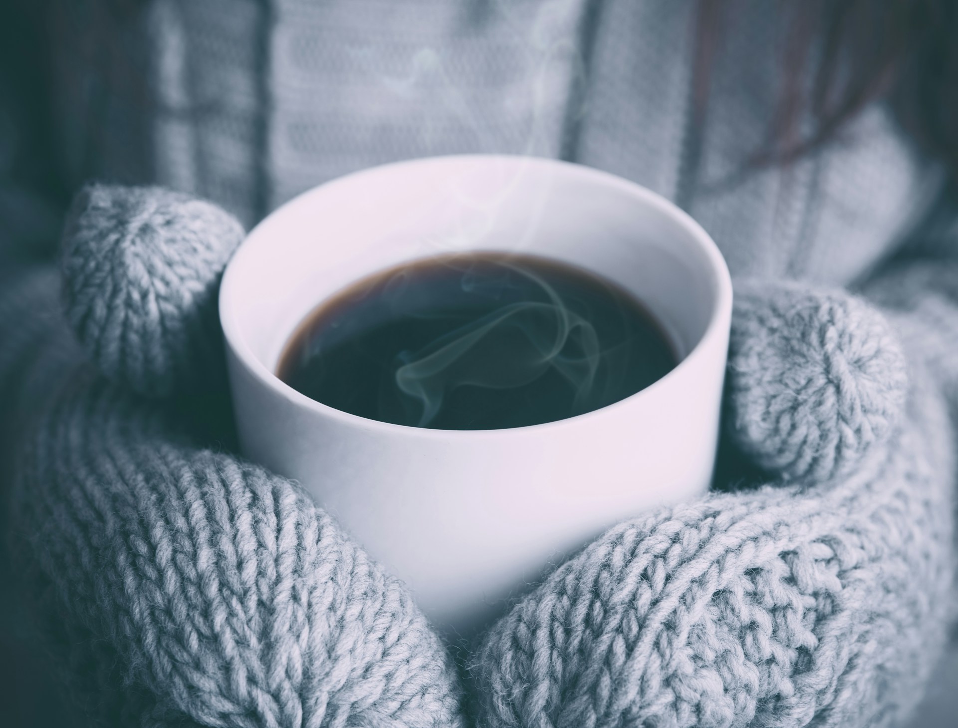 cup of coffee in hands with mittens, cold, winter